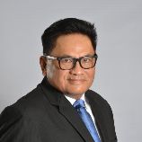 Photo of John Sam, Senior Partner